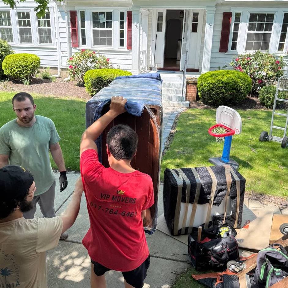 VIP Movers wrapping furniture for transport